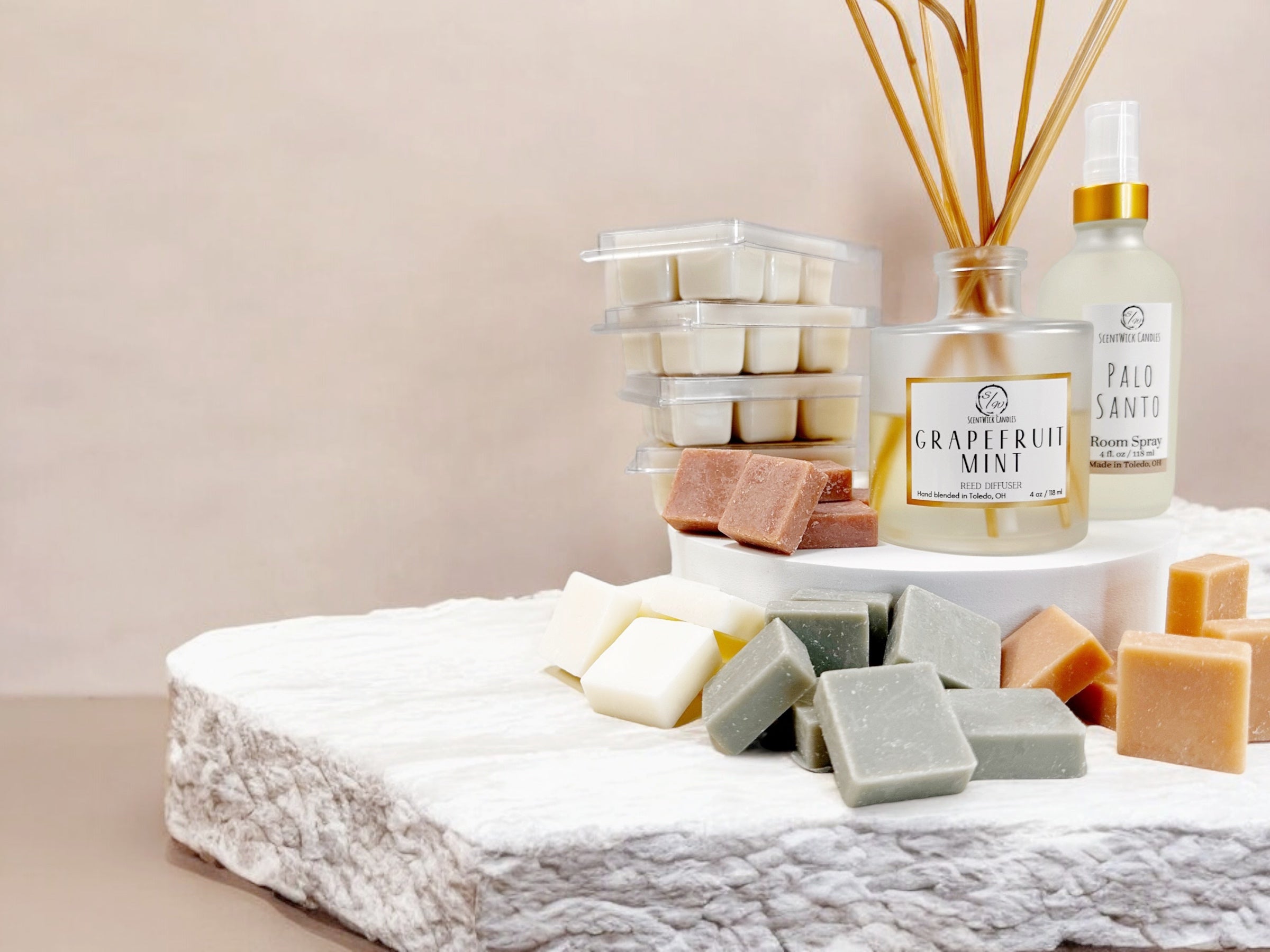 room spray, reed diffuser and wax melts displayed on a white stone slab