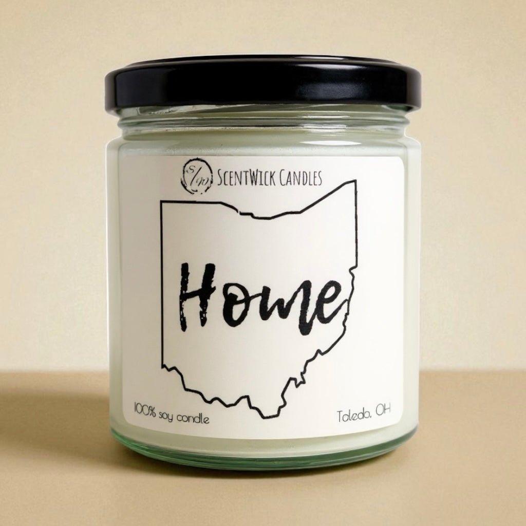 Candle jar with 'Home' Ohio outline label on a beige background