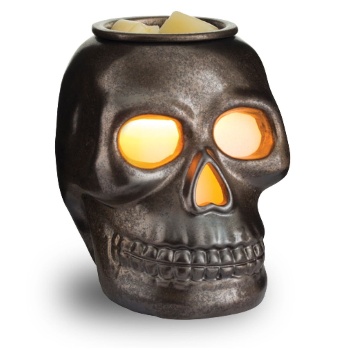 Skull-shaped wax melt warmer with glowing eyes on a white background