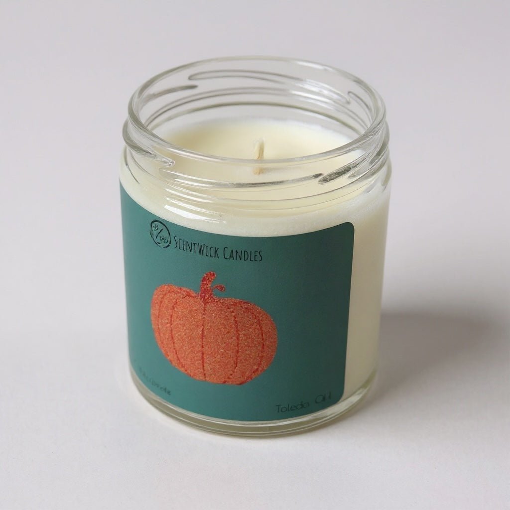 Taylor Swift inspired Candle in a glass jar with a pumpkin label on a white background