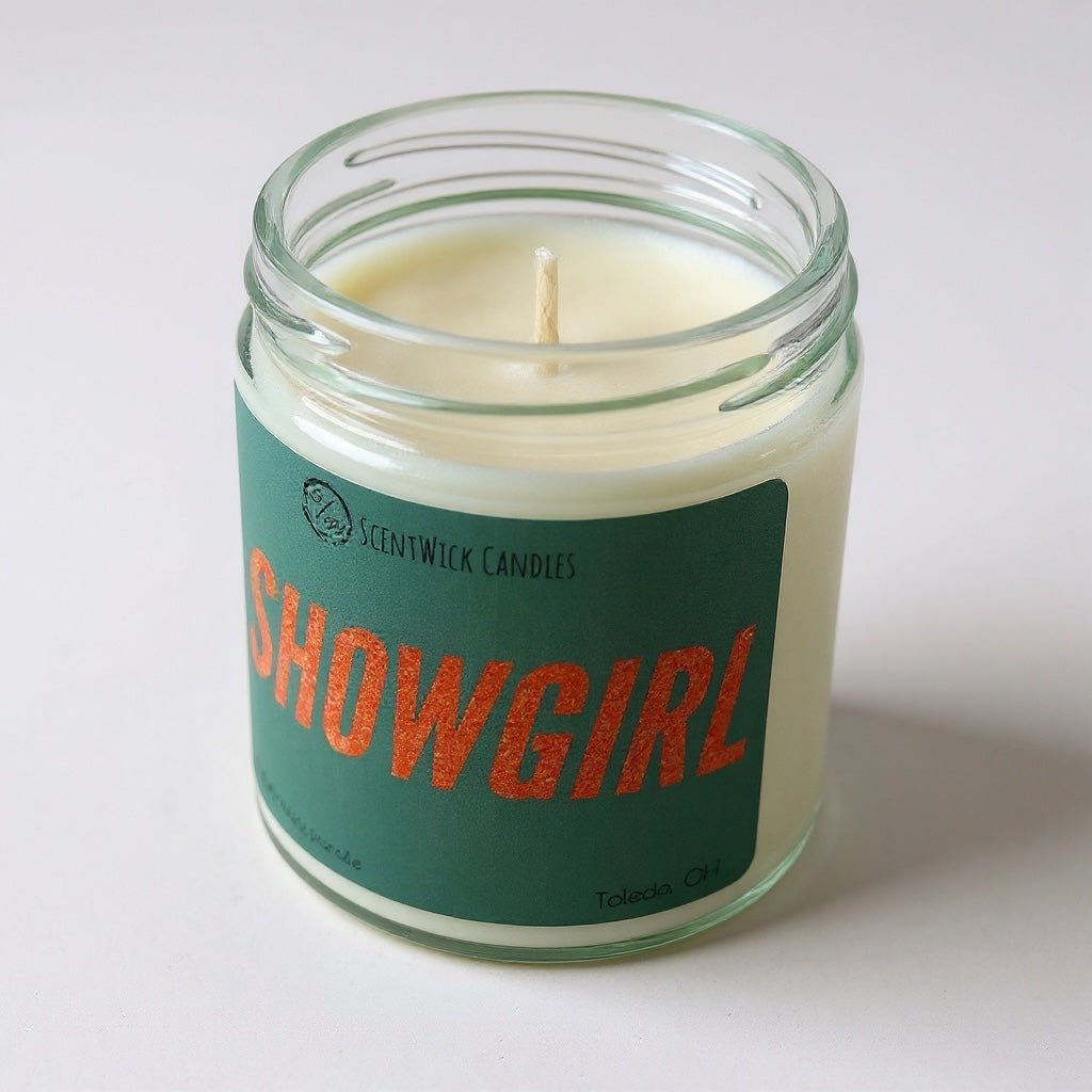 Taylor Swift inspired scented candle in a glass jar with a 'Showgirl' label on a white background