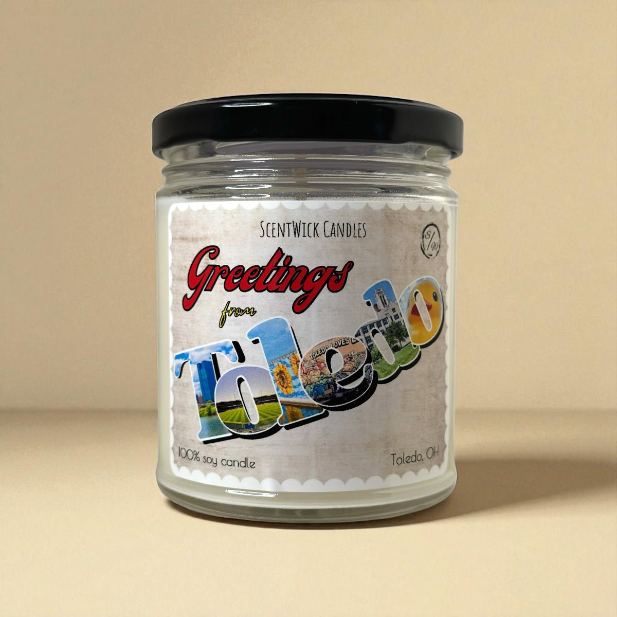 ScentWick candle jar with 'Greetings from Toledo' label on a beige background