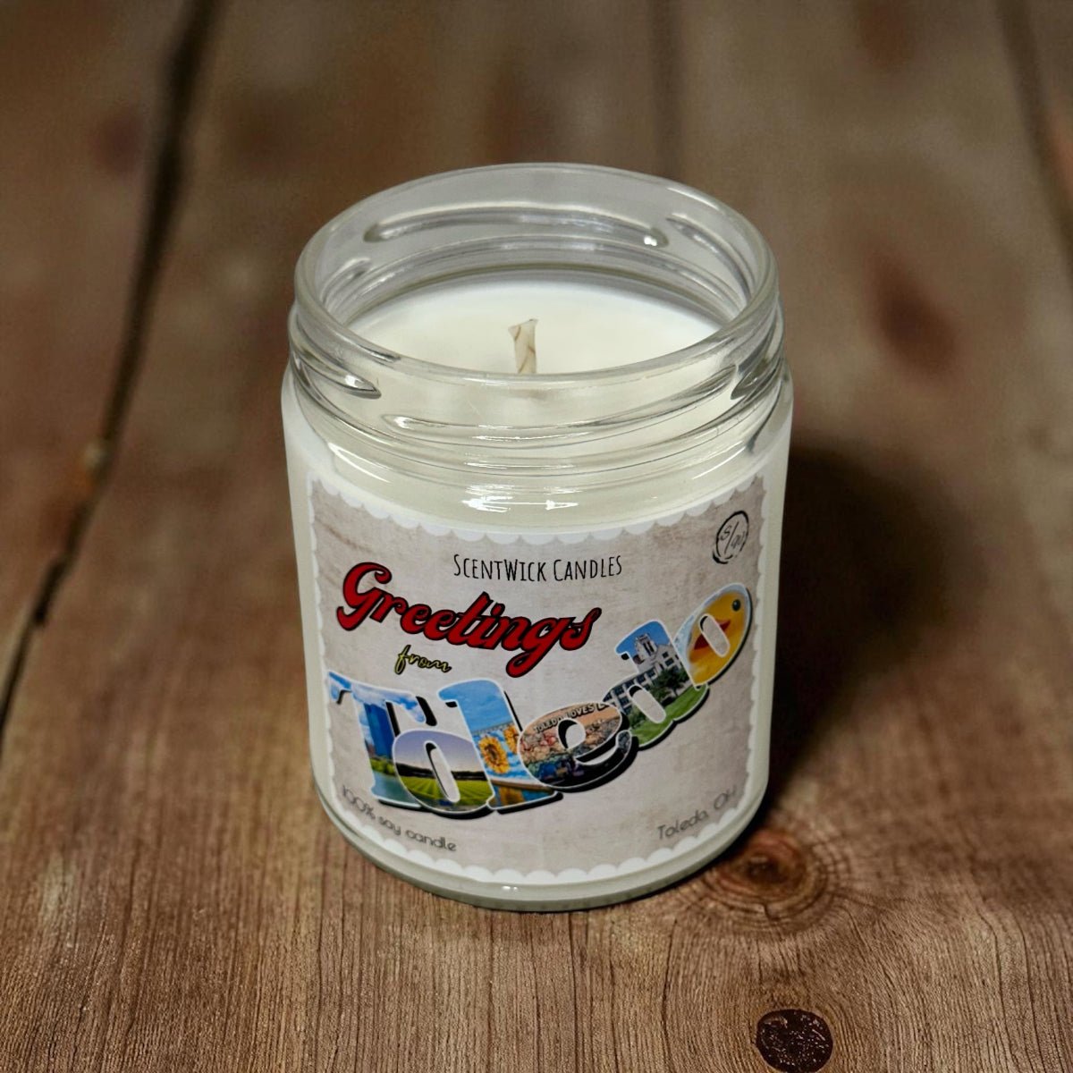 ScentWick Candles jar candle with 'Greetings from Toledo' label on a wooden surface