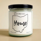 Candle jar with 'Home' Ohio outline label on a beige background