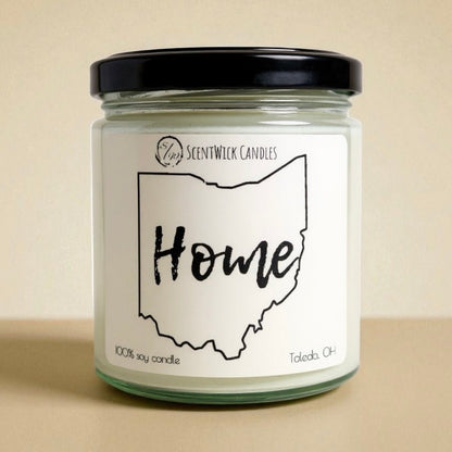 Candle jar with 'Home' Ohio outline label on a beige background