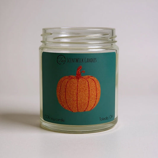 ScentWick Candles Taylor Swift inspired jar with pumpkin design on a teal label against a light gray background