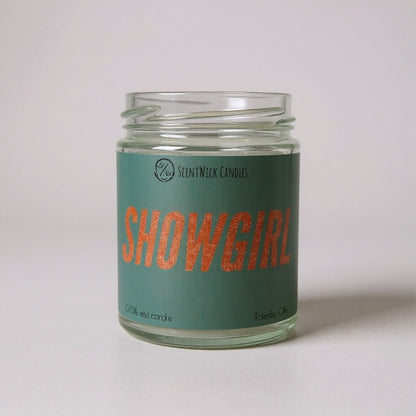 Taylor Swift inspired Candle jar labeled 'Showgirl' with a green label on a light gray background