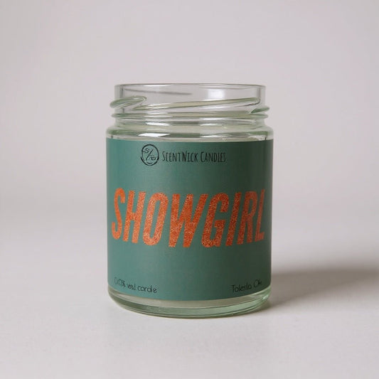 Taylor Swift inspired Candle jar labeled 'Showgirl' with a green label on a light gray background