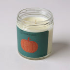 Taylor Swift inspired Candle in a glass jar with a pumpkin label on a white background