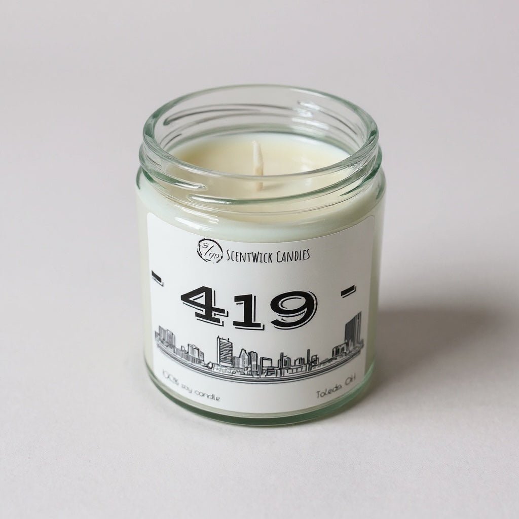 ScentWick candles jar with a lit candle on a white background