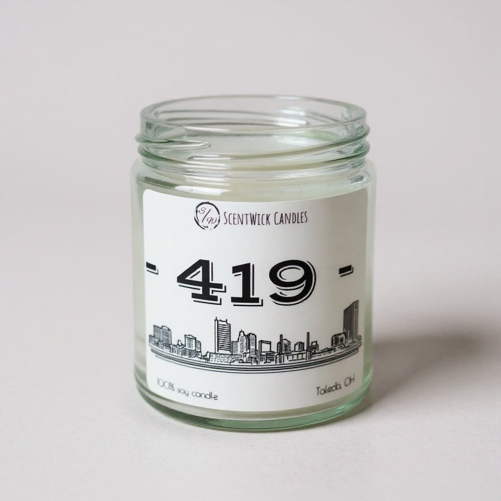 Candle jar with a label featuring the area code 419 and a Toledo cityscape design on a white background.