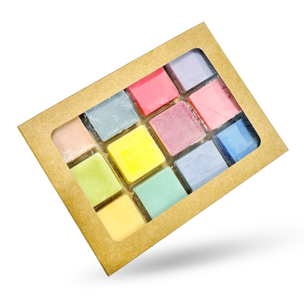 Set of colorful wax melts in a cardboard box on a white background